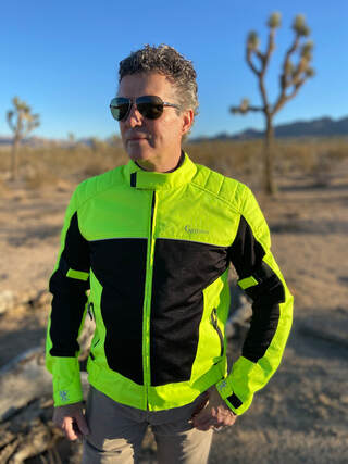 man standing in the desert wearing gryphon protective motorcycle jacket and sunglasses