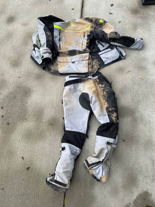 gryphon protective motorcycle gear laid out on the ground showing the results of a motorcycle accident